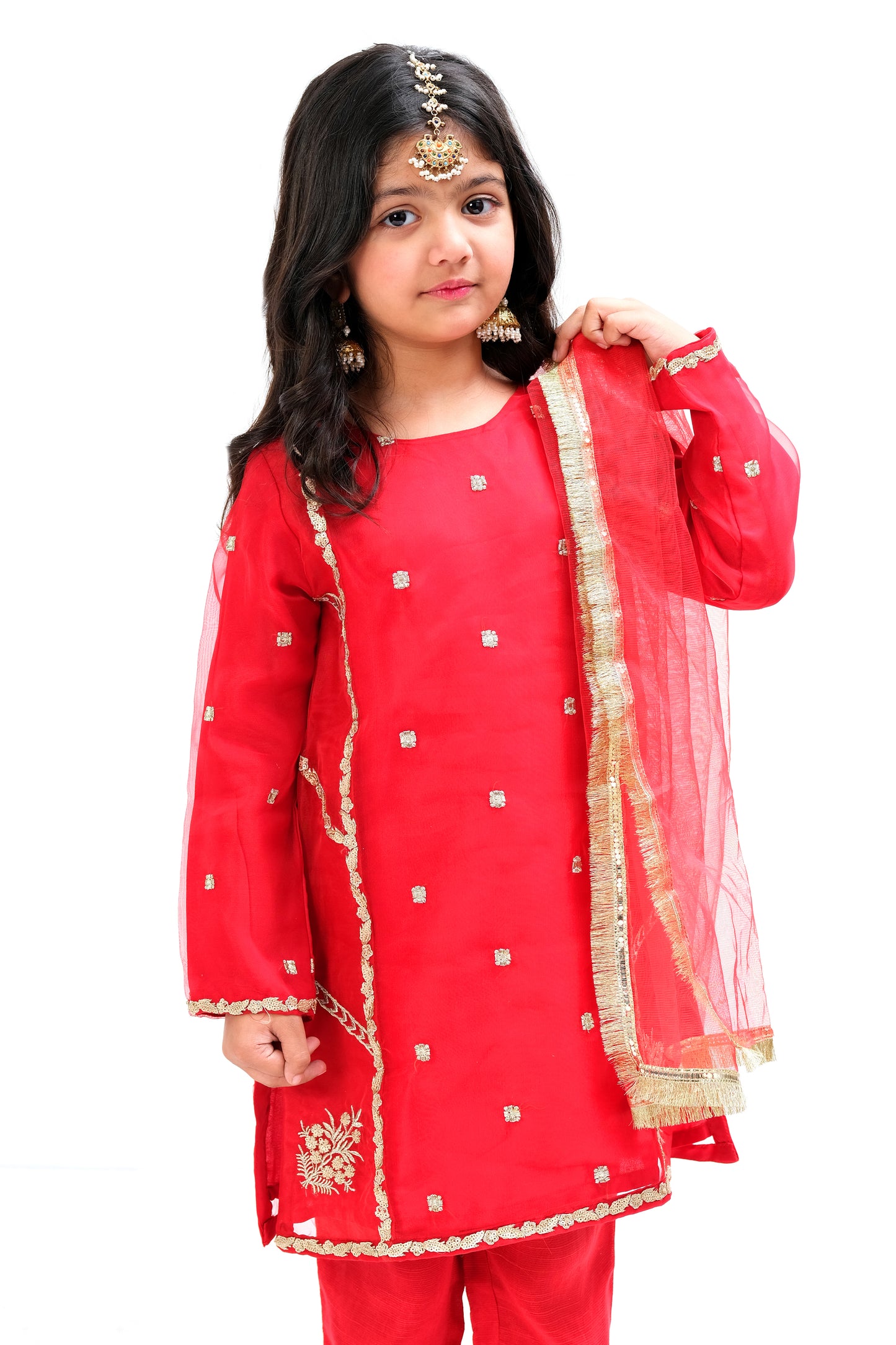 Cherry red organza paneled ethnic shirt with intricate golden embroidery . Red raw silk trouser with net dupatta.