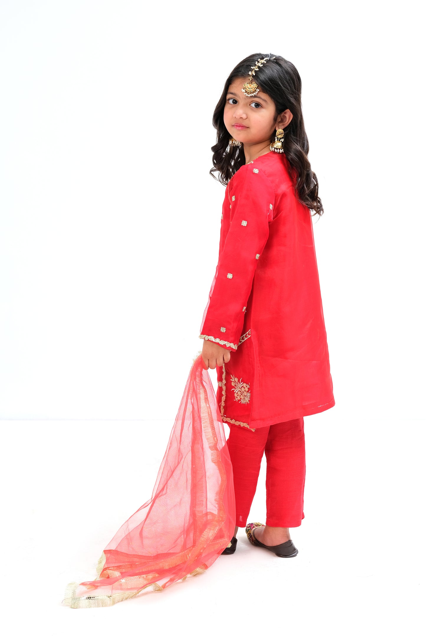 Cherry red organza paneled ethnic shirt with intricate golden embroidery . Red raw silk trouser with net dupatta.