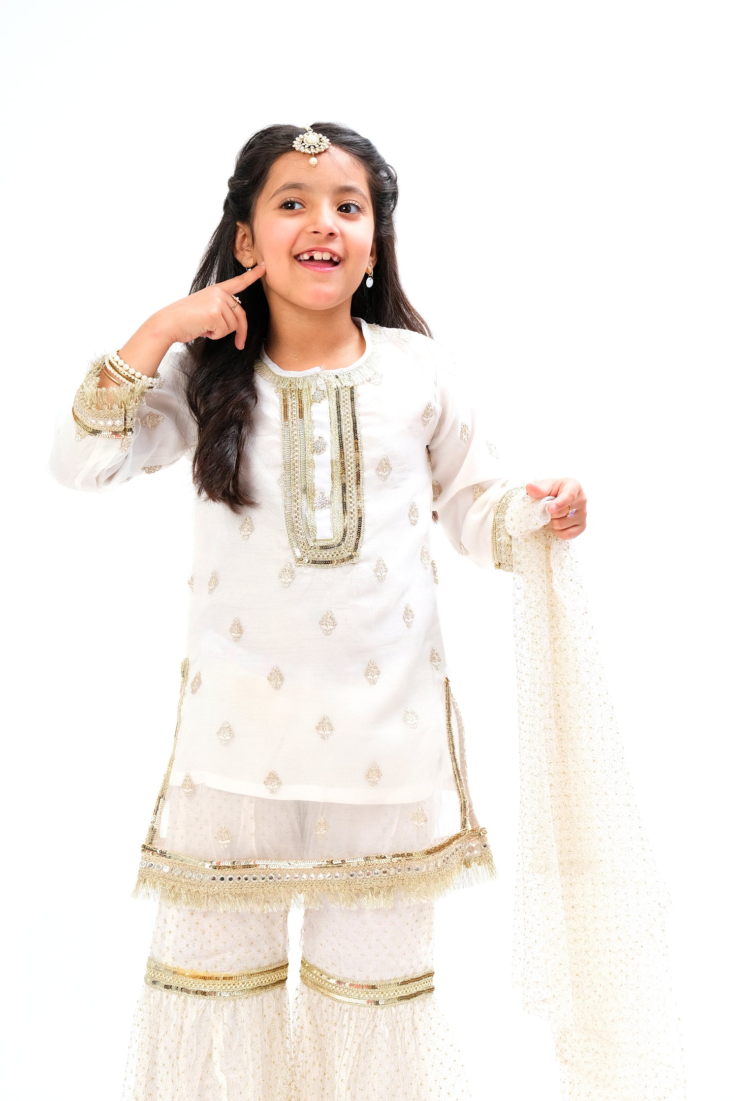 White organza shirt with intricate embroidery motive all over the shirt and golden laces on neck and sleeves. Glitter net gharara and dupatta